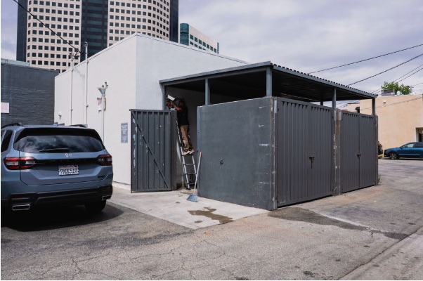 Exterior trash-enclosure deployment at a commercial site