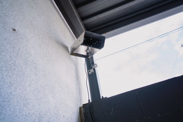Emitter mounted under a canopy edge for yard coverage