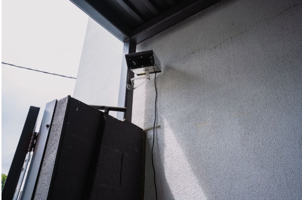 Wall-mounted emitter covering a gated service yard